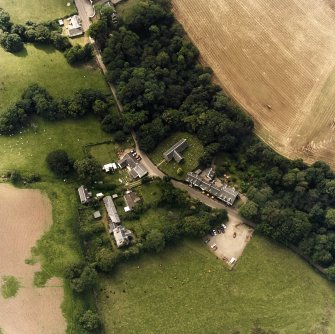 Oblique aerial view centred on the church, churchyard and hotel, taken from the NE.