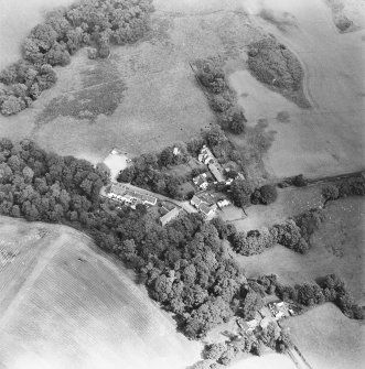 Oblique aerial view centred on the church, churchyard and hotel, taken from the WSW.