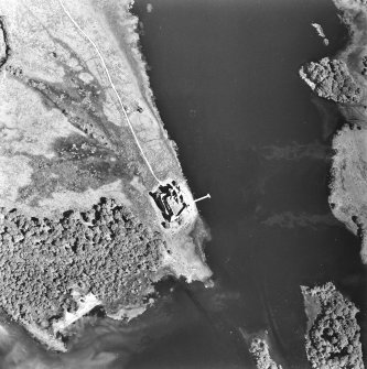 Oblique aerial view centred on the remains of the castle, taken from the W.