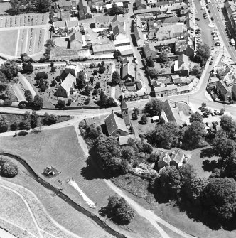 Oblique aerial view of Biggar centred on Biggar Church, churchyard and Moat Park Church, taken from the W.