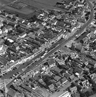 Oblique aerial view of Biggar High Street centred on the Corn Exchange, taken from the SW.