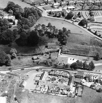 Oblique aerial view centred on the museum and watermill with farmsteading and manse adjacent, taken from the WSW.