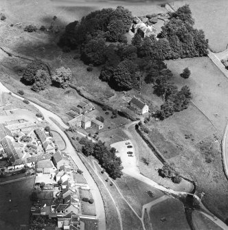 Oblique aerial view centred on the museum and watermill with manse, farmsteading, footbridge and ford adjacent, taken from the SSW.