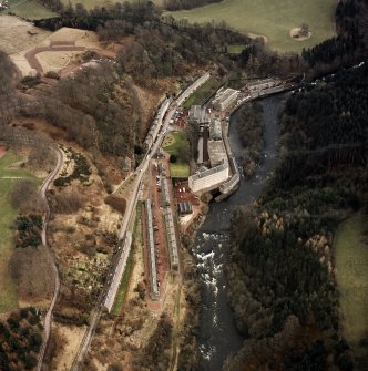 Oblique aerial view centred on the village of New Lanark, taken from the WNW.