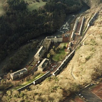 Oblique aerial view of New Lanark centred on the school and mills, taken from the ESE.