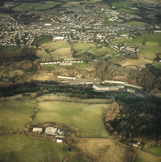Oblique aerial view centred on New Lanark with the town of Lanark adjacent, taken from the SW.