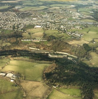 Oblique aerial view centred on New Lanark with the town of Lanark adjacent, taken from the SSW.