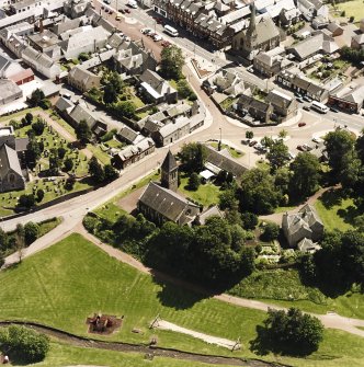 Oblique aerial view of Biggar centred on Moat Park Church, taken from the NW.