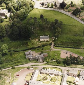 Oblique aerial view centred on the museum and watermill with farmsteading and manse adjacent, taken from the SSW.