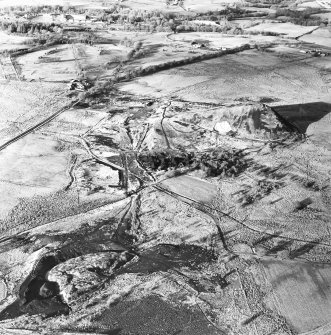 Oblique aerial view centred on the remains of the coal mines, taken from the SE.