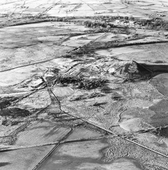 Oblique aerial view centred on the remains of the coal mines, taken from the SE.