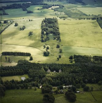 Oblique aerial view centred on the curling pond and formal gardens with the ruins of Carmichael House and the cottages adjacent, taken from the NNW.