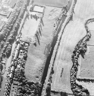 Oblique aerial view of Castlecary centred on the Forth and Clyde canal and lock 18, taken from the ENE.