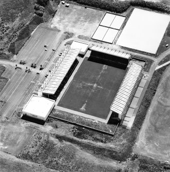 Oblique aerial view centred on the football stadium, taken from the NNW.