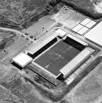 Oblique aerial view centred on the football stadium, taken from the NW.