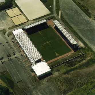 Oblique aerial view centred on the football stadium, taken from the NE.