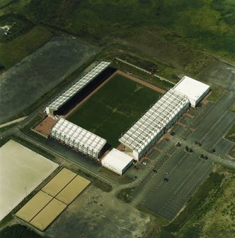 Oblique aerial view centred on the football stadium, taken from the SE.