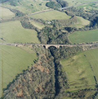 Oblique aerial view centred on the railway viaduct, taken from the WSW.