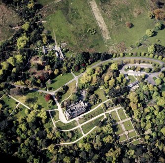Oblique aerial view centred on the country house, walled garden and cottages, taken from the SSE.