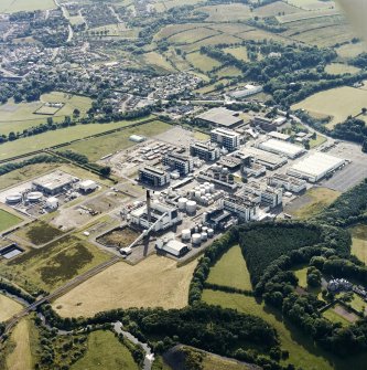 Oblique aerial view of the chemical works with the country house adjacent, taken from the NE.