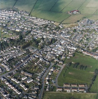 Oblique aerial view of the town centred on the church, taken from the SW.