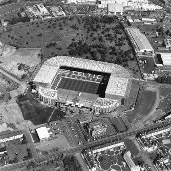 Oblique aerial view, taken from the SW. Centred on Celtic Park football stadium, and showing the Eastern Necropolis graveyard at the top of the photograph.