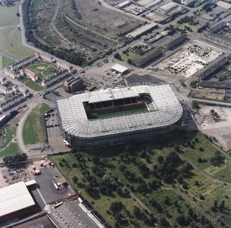 Oblique aerial view, taken from the NE.
Centred on Celtic Park football stadium, and showing the Eastern Necropolis graveyard in the bottom right-hand corner of the photograph.