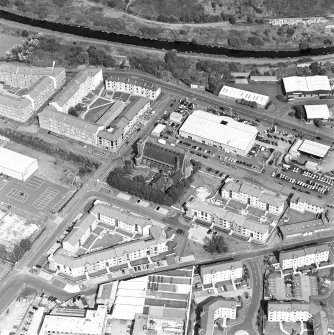 Oblique aerial view centred on Saint Columba's Roman Catholic Church. The Forth and Clyde canal is visible in the top half of the photograph.