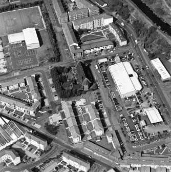 Oblique aerial view centred on Saint Columba's Roman Catholic Church. The Forth and Clyde canal is visible in the top right-hand corner of the photograph.