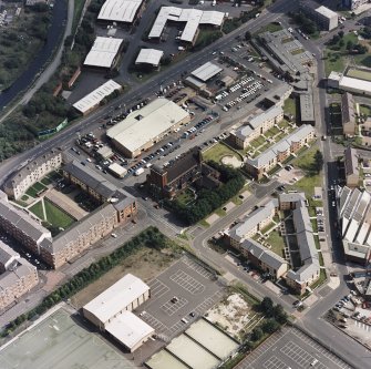 Oblique aerial view centred on Saint Columba's Roman Catholic Church. The Forth and Clyde canal is visible in the top left-hand corner of the photograph.