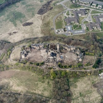Oblique aerial view centred on the hospital partly under demolition, taken from the SW.