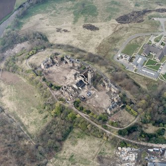 Oblique aerial view centred on the hospital partly under demolition, taken from the S.