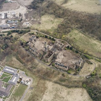 Oblique aerial view centred on the hospital partly under demolition, taken from the N.