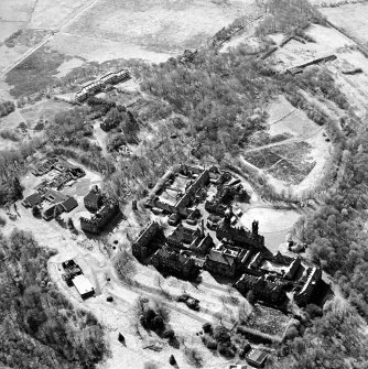 Oblique aerial view centred on the hospital, halls, nurses homes, former mortuary, and workshops, taken from the E.
