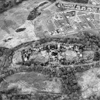 Oblique aerial view centred on the hospital partly under demolition, taken from the SSW.
