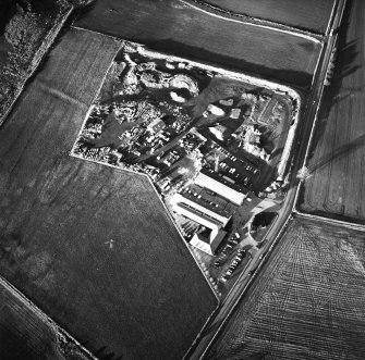 Oblique aerial view centred on the works and the remains of the field boundary, taken from the SE.