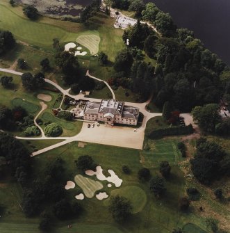 Oblique aerial view centred on the country house and walled garden with the coach house, stables and the remains of the tower-house adjacent, taken from the E.