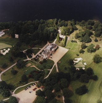 Oblique aerial view centred on the country house and walled garden with the remains of the tower-house adjacent, taken from the SE.