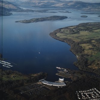 General oblique aerial view looking over the shopping centre, visitor centre, pier and slipway across Loch Lomond, taken from the SSW.