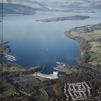 General oblique aerial view looking over the shopping centre, visitor centre, pier and slipway across Loch Lomond, taken from the S.
