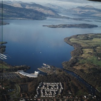 General oblique aerial view looking over the shopping centre, visitor centre, pier and slipway across Loch Lomond, taken from the SSE.