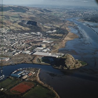 General oblique aerial view looking along the N bank of the River Clyde across the castle, fort, football ground, shipyard, works and the remains of the shipyard and works, taken from the W.