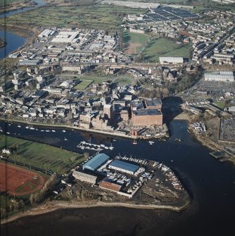 Oblique aerial view centred on the boat yard and whisky distillery, taken from the SSW.