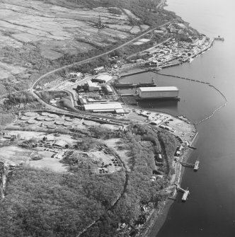 Oblique aerial view centred on the submarine base with the military training camp and oil fuel depot adjacent, taken from the NNW.