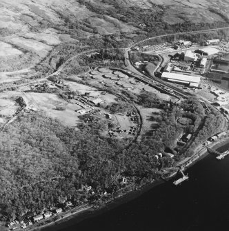 Oblique aerial view centered on the military training camp with the farmsteading and oil fuel depot adjacent, taken from the NW.
