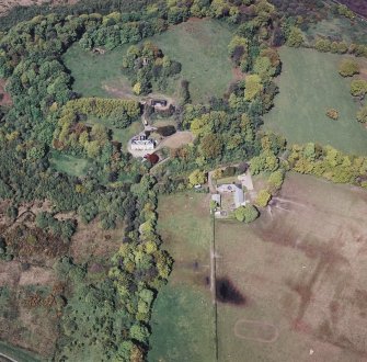 Oblique aerial view centred on the country house, stable, stable block and tower, taken from the SSE.