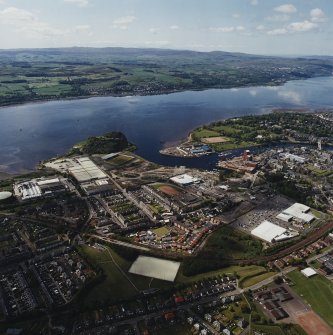 General oblique aerial view of Dumbarton looking across the works, football ground, castle, whisky distillery and the River Clyde towards Langbank, taken from the NE.