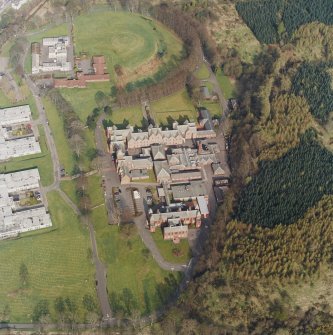 Oblique aerial view centred on the asylum, hospital and garden feature, taken from the WSW.