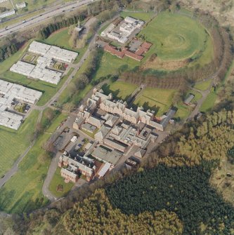 Oblique aerial view centred on the asylum, hospital and garden feature, taken from the SW.
