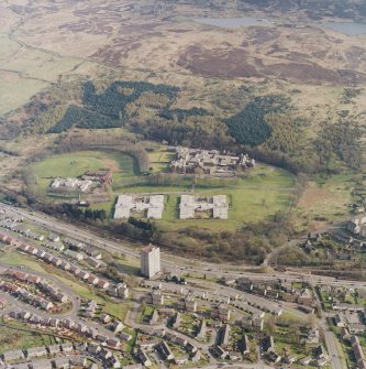 Oblique aerial view centred on the asylum, hospital and garden feature, taken from the NW.